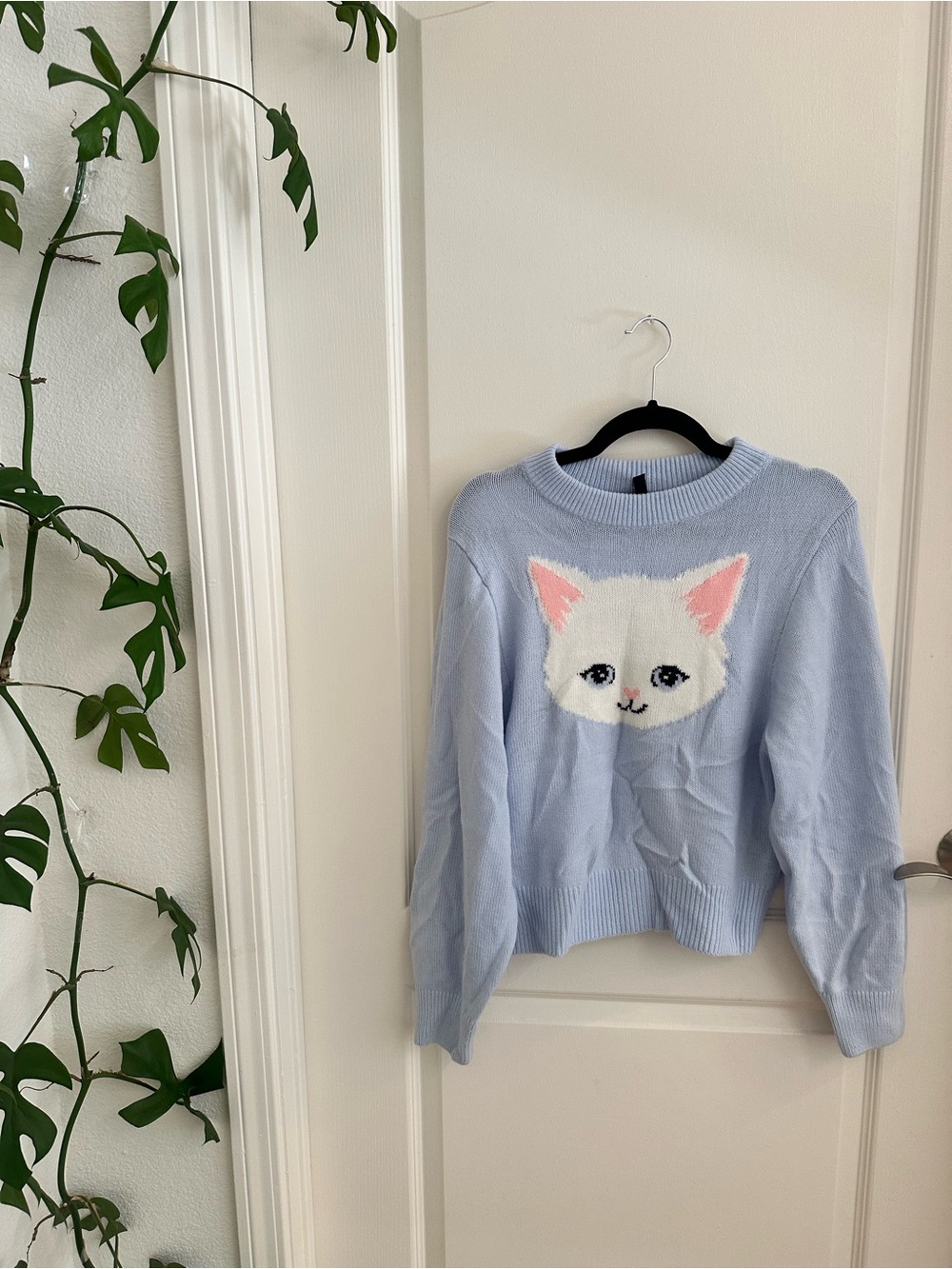 H&M Light Blue Crewneck Sweater with White Kitten Motif and Pink Ear Accents
